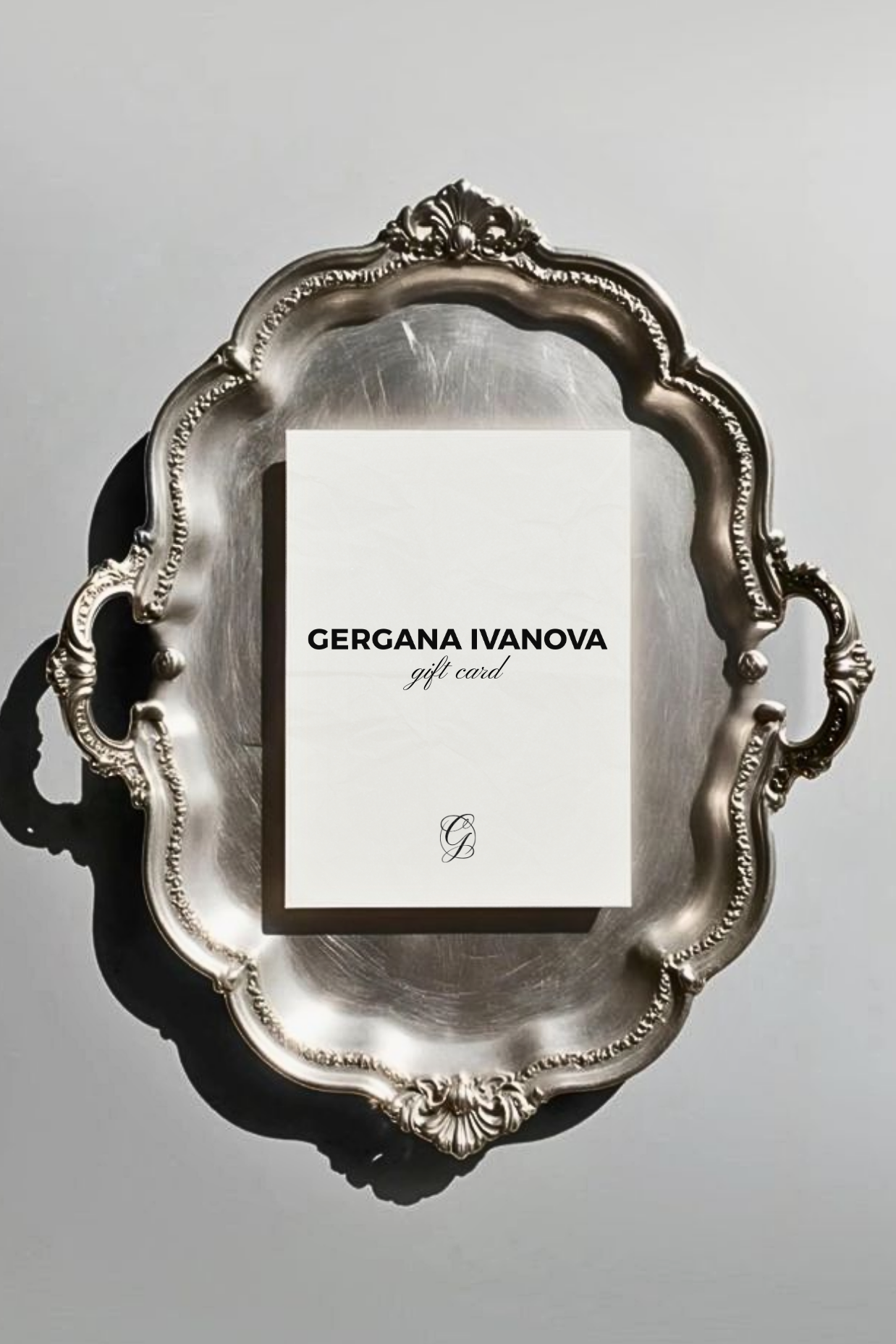 Silver decorative tray with a gift card featuring 'Gergana Ivanova' on a gray background