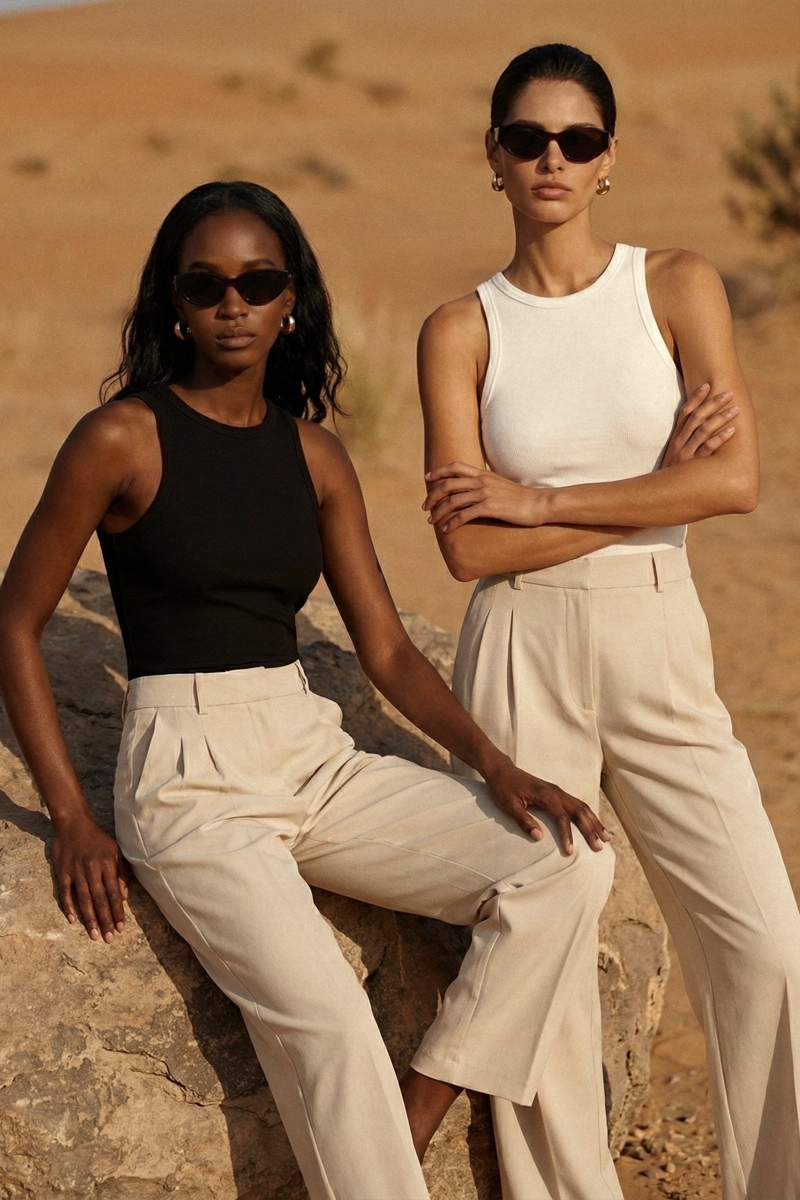 Two women in stylish outfits standing in a desert setting