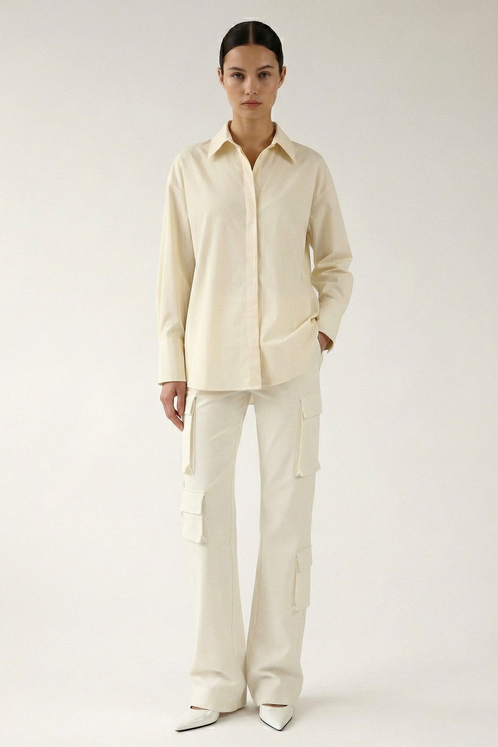 Person wearing a cream-colored outfit on a white background