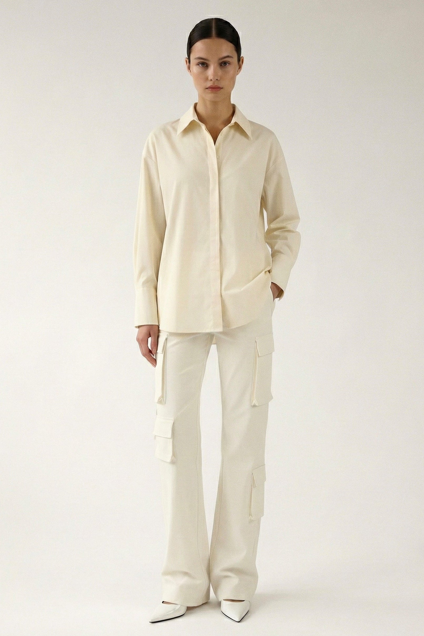 Person wearing a cream-colored outfit on a white background