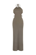 A beige, sleeveless, halter neck, cutout back, and tie-dress with a halter neckline.